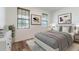 Relaxing bedroom featuring natural light from two windows, neutral color tones and modern art at 5876 Bar Ranch Rd, St Cloud, FL 34771