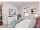 Cozy bedroom with a queen-sized bed, a white dresser and two decorative paintings at 5876 Bar Ranch Rd, St Cloud, FL 34771