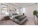 Spacious bedroom with a tray ceiling, two windows, neutral tones and art pieces at 5876 Bar Ranch Rd, St Cloud, FL 34771
