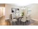 Dining room with seating for six, modern light fixture, and elegant decor at 5876 Bar Ranch Rd, St Cloud, FL 34771