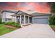 Charming single-story home with a well-manicured lawn, covered porch, and a two-car garage at 5876 Bar Ranch Rd, St Cloud, FL 34771