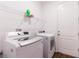 Functional laundry room with a washer, dryer, and wire shelving for storage at 5876 Bar Ranch Rd, St Cloud, FL 34771