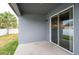 Outdoor patio featuring a sliding glass door to the interior, with a lush green lawn beyond at 5876 Bar Ranch Rd, St Cloud, FL 34771