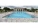 Relaxing community pool area with lounge chairs and shaded cabana offering a perfect spot for leisurely days at 5876 Bar Ranch Rd, St Cloud, FL 34771