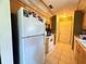Functional kitchen featuring white appliances, tile floors, and warm-toned cabinetry at 622 Dromedary Ct, Kissimmee, FL 34759