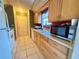 Bright kitchen featuring white appliances and warm-toned wood cabinets, offering a practical cooking space at 622 Dromedary Ct, Kissimmee, FL 34759