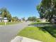 Quiet neighborhood street view featuring well-maintained lawns and mature trees providing ample shade at 622 Dromedary Ct, Kissimmee, FL 34759