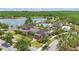 Community clubhouse with a pool, splash pad, and landscaping, plus a lake view, perfect for relaxation and recreation at 8378 Randal Park Blvd, Orlando, FL 32832