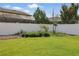 Lush backyard with green lawn, white fence, and planted garden area at 8378 Randal Park Blvd, Orlando, FL 32832