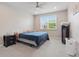Cozy bedroom with a large window, neutral walls, and carpet flooring at 8378 Randal Park Blvd, Orlando, FL 32832