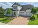 Beautiful two-story home boasting a spacious three-car garage and lovely landscaping at 8378 Randal Park Blvd, Orlando, FL 32832