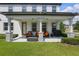 Inviting front porch with stone columns and cozy outdoor seating area at 8378 Randal Park Blvd, Orlando, FL 32832