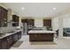 Gourmet kitchen featuring stainless steel appliances, dark cabinetry, and center island at 8378 Randal Park Blvd, Orlando, FL 32832