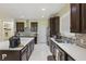 Well-equipped kitchen with granite countertops, dark wood cabinets, and stainless appliances at 8378 Randal Park Blvd, Orlando, FL 32832