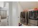 Convenient laundry room equipped with modern washer and dryer units and shelving at 8378 Randal Park Blvd, Orlando, FL 32832