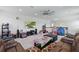 Open living room with a sectional couch, tv on the wall, and plenty of space for activities at 8378 Randal Park Blvd, Orlando, FL 32832