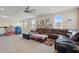 Open living room with a sectional couch, ' tents, and a view of the neighborhood at 8378 Randal Park Blvd, Orlando, FL 32832