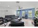 Spacious living room with tile floors, ceiling fan, and views of the backyard at 8378 Randal Park Blvd, Orlando, FL 32832