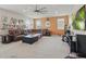 Spacious living room is complete with a large leather couch, ottoman, and a ceiling fan at 8378 Randal Park Blvd, Orlando, FL 32832