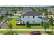 Back exterior view of a home featuring a spacious yard and a covered patio at 8378 Randal Park Blvd, Orlando, FL 32832