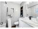 Bathroom with gray tile, a black framed mirror, shelving, and black matte fixtures at 106 Edgewater Dr, St Cloud, FL 34769