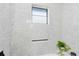 This modern bathroom features speckled gray walls and a window that provides natural light at 106 Edgewater Dr, St Cloud, FL 34769