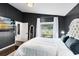 Primary bedroom featuring a dark accent wall, decorative mirror and a television with a beach scene at 106 Edgewater Dr, St Cloud, FL 34769