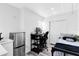 This bedroom has a mini fridge, desk, bed and closet at 106 Edgewater Dr, St Cloud, FL 34769