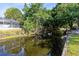 An inviting canal, surrounded by lush greenery, runs through the backyard at 106 Edgewater Dr, St Cloud, FL 34769