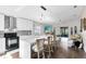 Bright kitchen with white cabinets and island seating open to the living room and outdoor screened patio at 106 Edgewater Dr, St Cloud, FL 34769