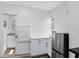 Eat-in kitchen featuring white cabinets, stainless steel appliances, and luxury vinyl plank flooring at 106 Edgewater Dr, St Cloud, FL 34769