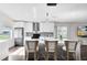 Modern kitchen with white cabinets, stainless steel appliances, and a stylish island with seating at 106 Edgewater Dr, St Cloud, FL 34769