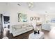 Bright living room featuring a modern sofa, stylish coffee table, and unique art, open to the kitchen area at 106 Edgewater Dr, St Cloud, FL 34769