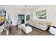 Bright living room with modern decor, sleek coffee table, leading to outdoor screened patio at 106 Edgewater Dr, St Cloud, FL 34769