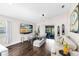 Cozy living room featuring a large screen TV and stylish decor, leading to a screened outdoor area at 106 Edgewater Dr, St Cloud, FL 34769