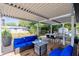 Inviting covered patio with ample seating, dining area, and scenic backyard views at 106 Edgewater Dr, St Cloud, FL 34769