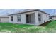 Exterior view of a house with a covered patio and well-maintained lawn at 109 Lily Ln, Poinciana, FL 34759