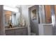 Elegant bathroom featuring double sinks, granite countertops, and glass shower at 109 Lily Ln, Poinciana, FL 34759