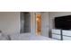 Bright bedroom view showcasing modern doors and a glimpse of a bar area at 109 Lily Ln, Poinciana, FL 34759