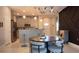 Open-concept kitchen and dining area with barstool seating, elegant pendant lighting, and modern decor at 109 Lily Ln, Poinciana, FL 34759
