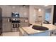 Elegant kitchen with gray cabinetry, granite counters, stainless steel appliances, and a convenient breakfast bar area at 109 Lily Ln, Poinciana, FL 34759