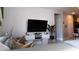 Modern living area featuring a sectional sofa, sleek entertainment center, and contemporary decor for a relaxing atmosphere at 109 Lily Ln, Poinciana, FL 34759