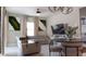 Cozy living room featuring a comfortable sectional sofa, modern decor, and ample natural light from large windows at 109 Lily Ln, Poinciana, FL 34759