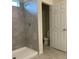 Clean bathroom featuring a tiled shower and modern fixtures at 1148 Sugarwood St, Davenport, FL 33837