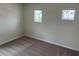 This bedroom features neutral walls, carpet, and two windows, offering a bright and versatile space at 1148 Sugarwood St, Davenport, FL 33837