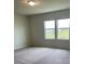 Bright bedroom featuring carpeted flooring and plenty of natural light at 1148 Sugarwood St, Davenport, FL 33837