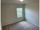 This bedroom features neutral walls, carpet, and a single window, offering a bright and versatile space at 1148 Sugarwood St, Davenport, FL 33837