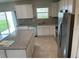 Modern kitchen featuring stainless steel appliances, granite countertops, and ample cabinet space at 1148 Sugarwood St, Davenport, FL 33837