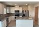 Well-equipped kitchen boasts stainless steel appliances and a center island at 1148 Sugarwood St, Davenport, FL 33837