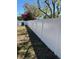 A new white vinyl fence defines the backyard perimeter on a sunny day at 1256 S Bumby Ave, Orlando, FL 32806